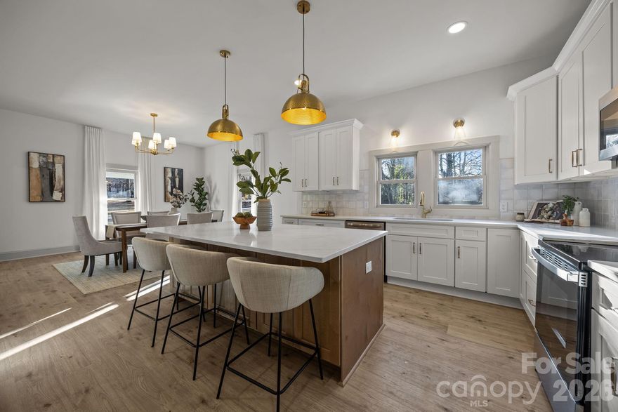 ***HUGE PRICE DROP*** Welcome to this beautifully renovated 1920’s home offering over 2,300 sq ft of thoughtfully designed living space with 3 bedrooms and 2.5 bathrooms. This stunning renovation preserves the character and charm of the era while seamlessly incorporating modern, high-end finishes throughout. Enjoy soaring high ceilings, elegant tray ceilings, and statement chandeliers that add timeless sophistication to every room. The chef’s kitchen features a huge island, quartz countertops, gorgeous cabinetry and plenty of room for entertaining. A spacious laundry/mudroom with a convenient drop zone right off the backdoor adds functionality for everyday living. The spacious primary suite features a large bedroom with an accent wall and barn door leading into the spacious en-suite bathroom with a tiled walk-in shower, neutral colors, and trendy tiled floors. The arched doorway opens to a dream primary closet complete with built-in wall units that provide exceptional storage and organization. Every detail has been carefully selected to blend historic charm with contemporary comfort while the HVAC, water heater, plumbing, and electrical have been replaced for peace of mind. This property is located in the quiet, small-town setting of Granite Quarry, offering peaceful living while remaining close to all conveniences, shopping, dining, and major routes. A rare opportunity to own a fully renovated historic home with modern luxury in an unbeatable location.