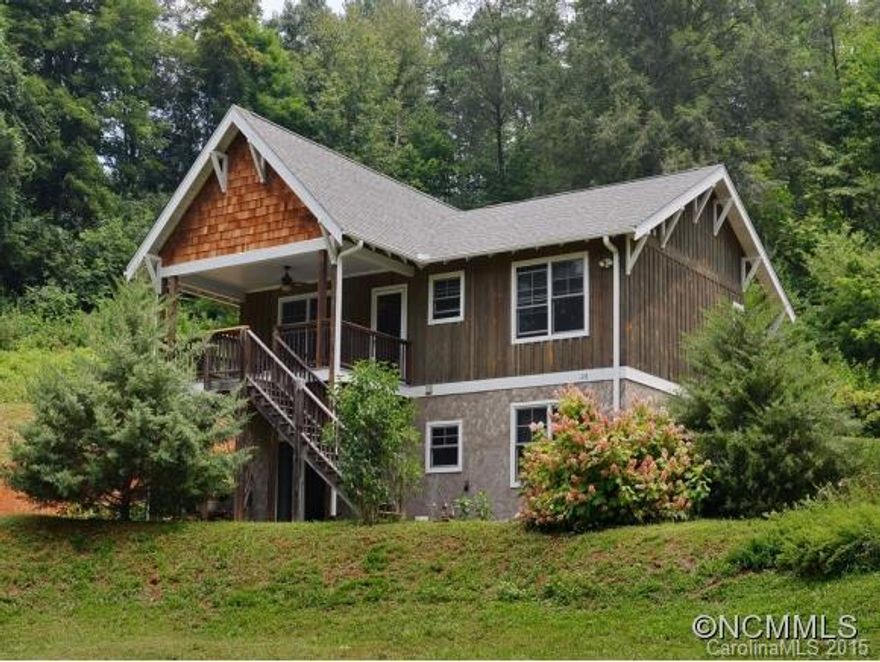 Custom built two bedroom, two bath, cottage on private acre lot. Light & bright with custom trim &moldings.Kitchen with granite tops & recessed lighting opens to deck.Large living room with fireplace. Ceiling fans, solid core doors, & hardwood floors throughout.Lives large! Inviting covered front porch.Full poured concrete daylight basement ready for expansion.Partially framed & stubbed for additional bath.Outbuilding for additional storage.