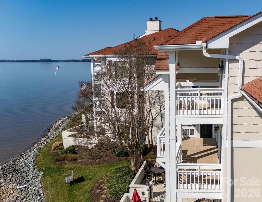 Fantastic waterfront opportunity on Lake Norman in the highly desirable community of Biscayne/Kings Point!  This END UNIT two-story condo has 3 bedrooms/3 full baths and stunning long range, year round water views.  Similar renovated floor plans have sold for well over $1M in Cornelius.  At just over 2,000 sq ft, there is plenty room to spread out including use of a dedicated dining room, 2 story great room w/gas log fireplace and an upstairs loft/office space that's perfect for multiple purposes.  Other great features include dual primary suites that face the lake with ensuite baths upstairs and on the main level and include their own balcony's.  Two of the three bathrooms have been updated, built in shelving included in the great room and in many of the closets and the high quality kitchen cabinets are soft close.  Additional storage space is located near the front door and on the back patio. Enjoy swimming at the lakefront community pool after a long day out on the boat or take in a game of tennis/pickleball.  Easy walking distance to Safe Harbor Kings Point Marina to get your boat out.  Don't have a boat, no worries!  Boat club's are also an option and located at the marina.  Close to Birkdale Village, restaurants/bars, greenways, major highways and the airport.  The only thing missing is you!