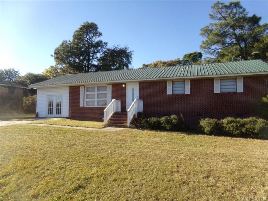 Don't miss this attractive brick ranch located on Hwy #9, close to Pageland City Limits.  It features a living room, kitchen, dining room, three bedrooms, two baths, new central heat and air, modern metal roof, enclosed carport/recreation room, paved driveway and more!  The walls are freshly painted and the kitchen/dining room feature original knotty pine walls.  The enclosed carport makes a great recreation/hobby space or storage and has window air conditioning for hot weather comfort.