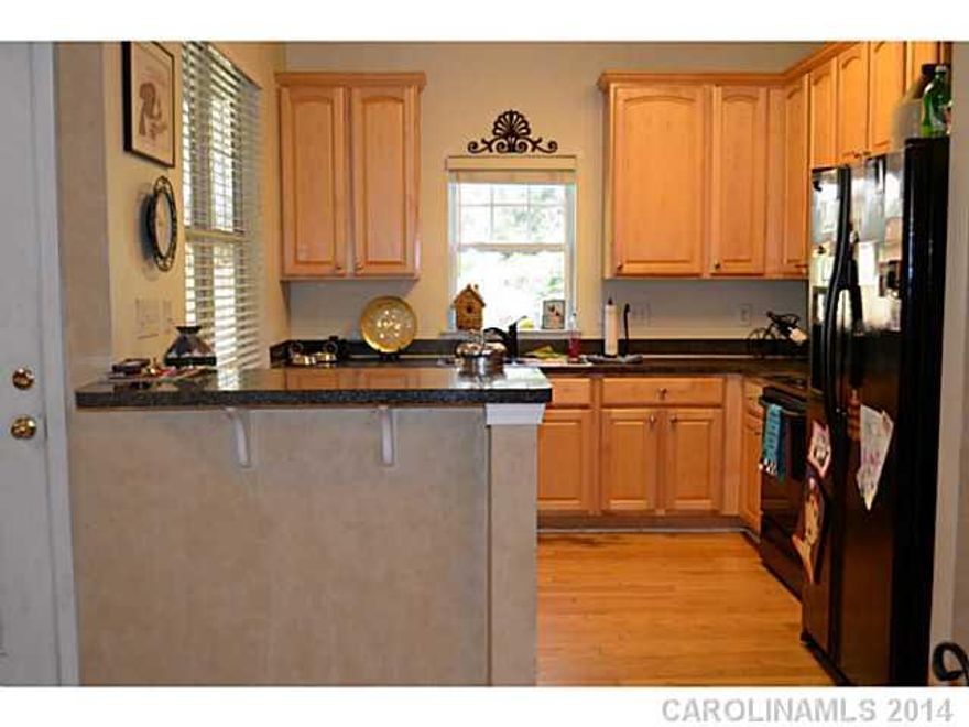 Great Ballantyne location, schools and shopping. 42 inch Maple cabinets, black GE appliance package, smooth top stove, microwave and side by side refrigerator. Snuggle up by the fireplace with TV niche above. Screen porch makes restful retreat in Spring and summer. Short walk to pool. Convenient second floor laundry and washer dryer remain. Finished garage. Gleaming Hardwood Floors just refinished. Bring your buyers!