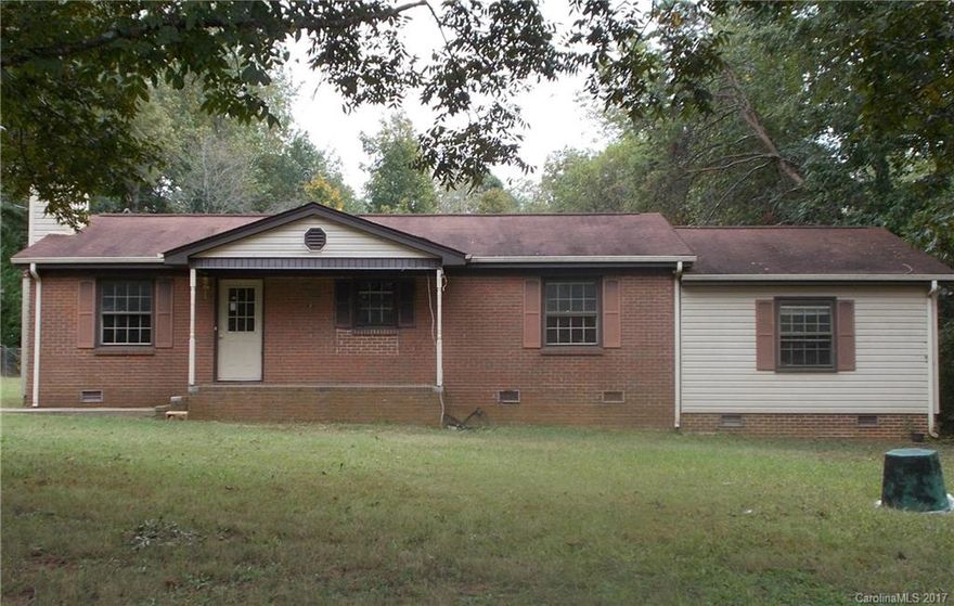 Brick ranch with almost 1 acre close to downtown and hospital. There is a larger front yard with shade trees and a very large and totally private back yard. The exterior has a full brick veneer. 4 bedrooms and 2.5 bathrooms.  Dining area off kitchen. Most rooms have paneling. Renovations are needed but the property is priced accordingly. Better hurry! Already getting calls.