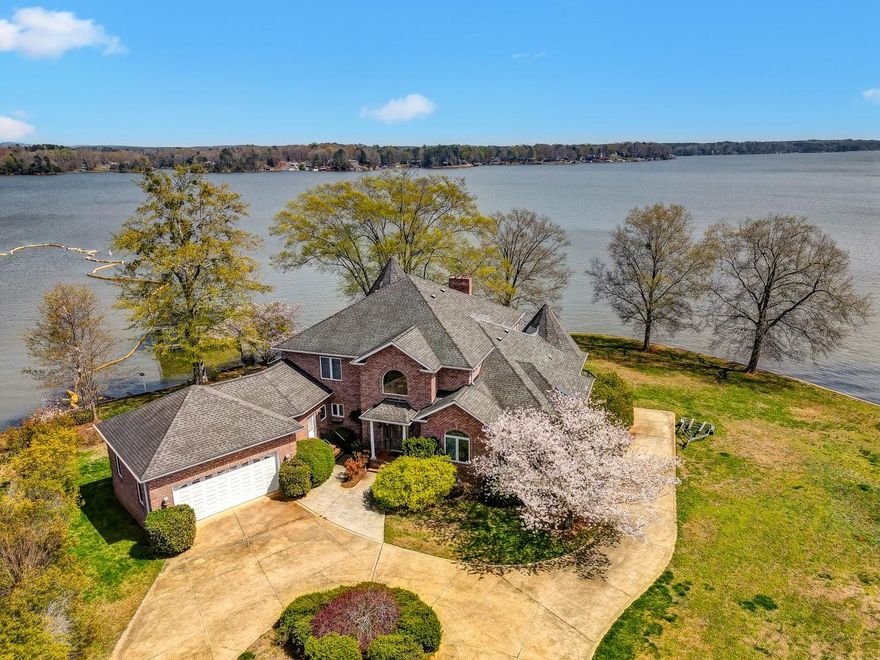 One of a kind main Channel peninsula prime lot on beautiful Lake Tillery that offers over 270 feet of water front living. This custom homes has so much character and so many possibilities.  As you walk in the front door you are welcomed with a two story foyer and two story living area with large windows over looking the lake.  You will fall in love with the massive rock fireplace and all the possibilities for entertaining in this home.  The primary suite is on the main and has an additional sitting area for enjoying lake mornings, this property also has an additional bedroom on the main, over 639 feet of deck area and a screened porch with 367 feet of entertaining space. The upstairs has two additional bedrooms and one bath.  Endless possibilities with an unfinished walk out basement with patio area.  The  basement has been framed, bathroom roughed in and some wiring. This property is being sold as is and does need some updating.  Make plans today to see this beauty!