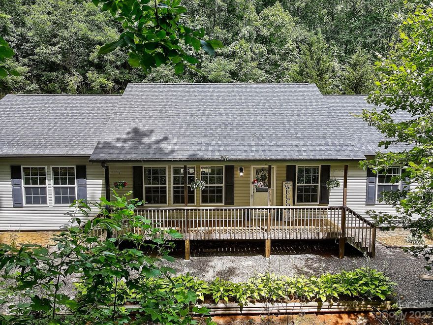 *Newly Renovated off Plott Creek Road* If you're looking for an interior which boasts an open and spacious floor plan, with large windows that flood the space with natural light, you've found it! The great room serves as the heart of the home, featuring high ceiling, fireplace insert and plenty of room to entertain guests or simply relax with your loved ones.  Continue on to find the large Kitchen which flows nicely with a convenient center island as well as a breakfast bar.  Located near desirable town of Waynesville, this home offers the best of both worlds – seclusion and convenience. Explore the nearby hiking and biking trails, experience the charm of downtown Waynesville with its vibrant arts scene and local boutiques, or take a short drive to the renowned Blue Ridge Parkway.