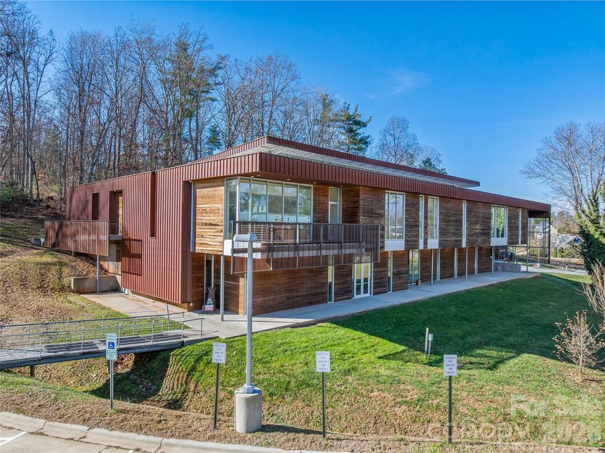 Exceptional and award-winning modern industrial facility on a 3.91± acre campus just 15 minutes north of downtown Asheville is now available for sale. The former home of Echoview Fiber Mill is a former Gold LEED–certified property purpose-built for long-term sustainability, combining cutting-edge green design with operational efficiency to reduce carbon footprint, lower operating costs, and create a healthier, high-performance workplace environment. Zoned OU (Open Use), the 18,230 SF facility offers outstanding flexibility and is equipped with a solar energy system, high-volume 3-phase power, a loading dock and delivery door, internal floor drains, and approximately 40 on-site parking spaces, making it ideal for a wide range of industrial, creative, showroom, R&D, or office users. Interior features include polished concrete floors, a modern showroom/reception area, elevator access, secure badge-controlled entry, multiple private offices, spacious conference rooms, two break rooms, and dramatic floor-to-ceiling windows that flood the space with natural light, all complemented by a prime location just 0.3 miles from I-26 with easy access to I-40 and only 30 minutes to Asheville Regional Airport—making this a rare opportunity to acquire a sustainable, high-functioning, and visually impressive facility in one of Western North Carolina’s most desirable markets.