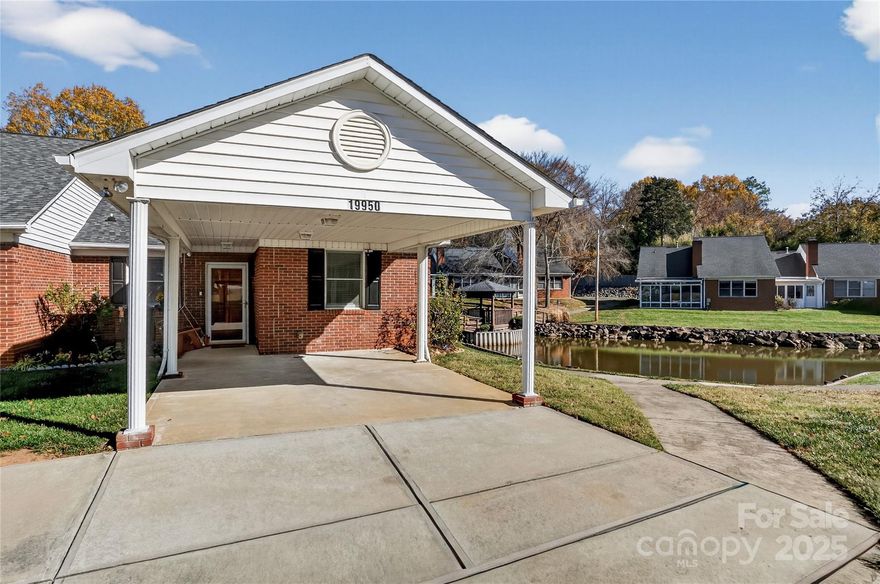 This beautifully maintained end unit brick 2-bedroom, 2-bath townhome offers peaceful living with a lovely view of the community gazebo and pond. The bright living room features vaulted ceilings, a cozy gas-log fireplace, and an enclosed porch perfect for morning coffee, conversation, and relaxation. Recent improvements include new quartz countertops and a 2024 water heater with an extended warranty. The home also offers spacious attic storage with pull-down access and a convenient carport. Twin Oaks residents enjoy walking paths, a pool, and a clubhouse.  This welcoming, well-kept neighborhood is ideal for daily strolls and neighborly visits. Move-in ready and perfectly located, this townhome has everything you need for comfortable, low-maintenance living in the heart of Cornelius!