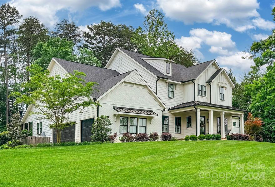 Escape to your own slice of paradise with this stunning farmhouse-style home nestled on a sprawling 1-acre lot.  As you approach, the covered front sitting porch beckons you. Step inside to discover a world of refined living, starting with the formal dining room adorned with wainscoting. The remarkable kitchen is equipped with a double oven, an island, breakfast bar, SS appliances, & a farmhouse sink complemented by a stunning backsplash, this space is as functional as it is beautiful. Prepare to be awe-inspired by the great room featuring cathedral ceilings & a striking stone gas log fireplace. Entertain with ease in the den, complete with a wet bar. The expansive primary bedroom on the main level exudes luxury w/ tray ceilings, a cozy sitting alcove, fireplace & a spa-like ensuite bathroom. A covered back porch invites you to unwind by another stone gas log fireplace, overlooking the private fenced yard. This property is a testament to exquisite craftsmanship & thoughtful design.