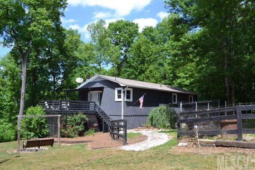 Private 4BR/2BA retreat near Wilson's Creek, a federally designated Wild and Scenic River. Nice mountain view and seclusion on 1 acre lot with some fenced area. Open living/dining/kitchen area with fireplace and vaulted ceilings. Full finished basement has large family room, rec room, office, 4th BR and a full bath. All new carpet and vinyl. Outbuilding stays.