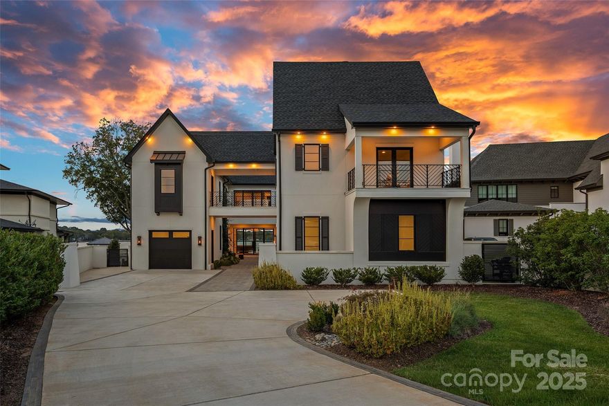 A rare offering on Lake Norman, this gated luxury waterfront estate redefines resort-style living in the heart of Cornelius. Perfectly situated to capture the breathtaking long-range views, this home blends architectural elegance with modern luxury, creating a private retreat designed for elevated yet effortless entertaining. Beyond your secluded courtyard adorned with gas lanterns, a world of refinement unfolds from soaring 10’ ceilings, wide plank white oak floors, and walls of glass that frame the water from nearly every room. The gourmet chef's kitchen is anchored by a grand island, 8-burner Wolf range with double oven, scullery, wine room, planning center, and bespoke coffee bar. Seamless transitions connect the dining and living spaces to an expansive veranda with gas fireplace, separate pool bath and built-in grilling area, all overlooking the heated pool & spa, and stunning lake views. The main-level primary retreat is a sanctuary unto itself with exceptional finishes, spa style bath, his-and-hers closets with private laundry, and tranquil water views. Upstairs, a sizable family lounge, flex room, built-in homework station, and three generously sized ensuite bedrooms provide comfort and privacy, while a breezeway leads to a private second living quarters, complete with kitchenette, full bath, and balcony. Outdoors, a private pier with sundeck and floating dock extends the living space onto the lake, offering the ultimate backdrop for boating, entertaining, or simply watching the sun set in seclusion. With no HOA, a premier Cornelius location, and every modern luxury thoughtfully curated, this residence stands among the most exclusive lakefront properties on Lake Norman. Offered fully furnished with every piece and accessory intentionally selected and professionally designed.