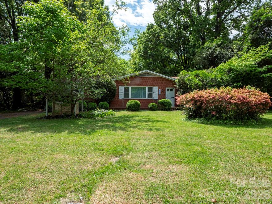 Charming brick ranch nestled in a secluded East Charlotte community, offering both privacy and convenience. Ideally located near the University area and Uptown, this home features a rustic-style kitchen and dining area full of character. Enjoy solid original hardwood flooring throughout many of the rooms, adding warmth and timeless appeal. The large laundry room has the potto be converted to a bathroom. Situated on a spacious lot, the property provides plenty of outdoor potential. Residents also enjoy access to a community lake, perfect for relaxing and enjoying nature.