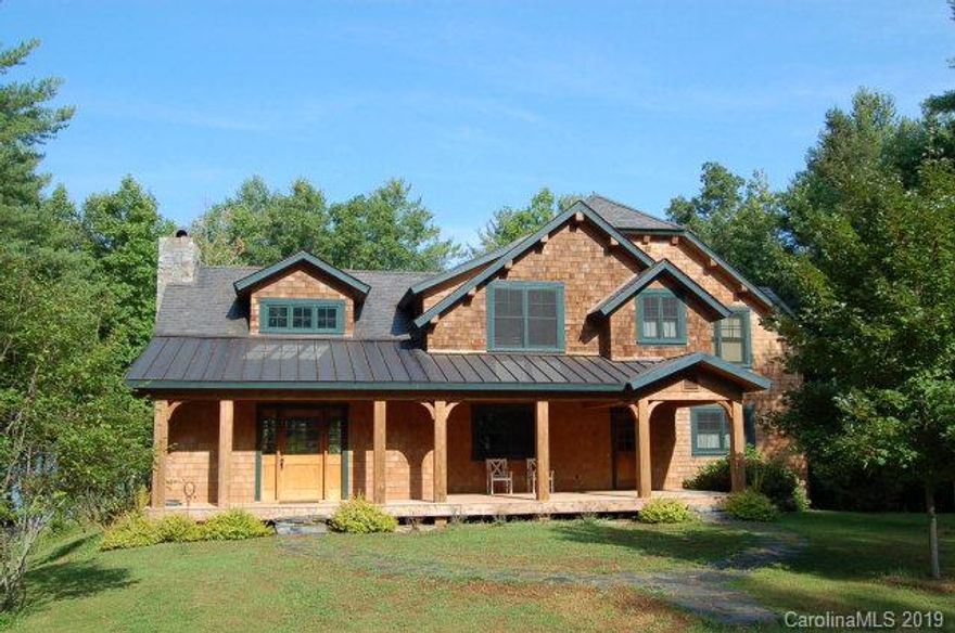 Open the private gate and continue down the tree-lined drive for several hundred yards before you even get a glimpse of this beautiful waterfront cabin. With water on three sides and the best view available on Lake James, these 9+ acres are irreplaceable. Watch the sunset over Mt. Mitchell and Dobson's Knob from your porch. Look directly into the Linville Gorge with miles of water in front of you. The post and exposed beam home feels warm and cozy while offering room for the whole family and more with 5 bedrooms and 3.5 baths. Features inside the house include Caribbean pine floors, Brazilian rosewood decking. An additional full bath is plumbed beside the 3rd floor game room. Want more? Build 3 more dwellings on this lot, if you'd like. The septic system is designed to accommodate 12 bedrooms! An easy walking path, high-quality dock.