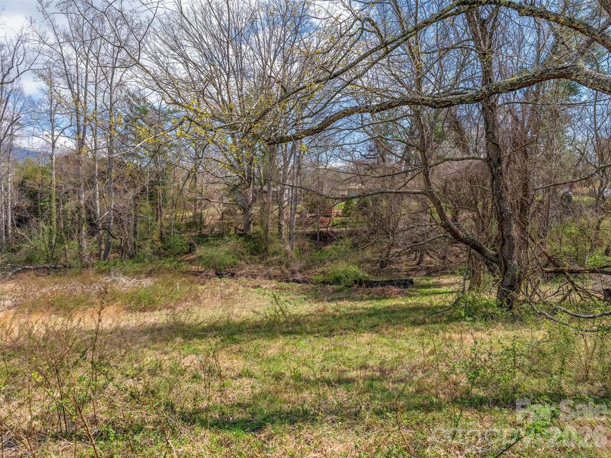 Nestle your home among the gently sloping topography of this beautiful, build-ready homesite—one of only three remaining lots in Overlook Place. With city sewer and community well water taps already in place, the land is primed for your vision. Located in Overlook Place, this property offers modern, mountain-inspired living in a convenient South Asheville setting.

You’ll be just minutes from Hendersonville Road and Long Shoals Road, providing effortless access to shopping, dining, parks, and everyday amenities. Nearby destinations include Biltmore Park Town Square (approximately 6 minutes) and Lake Julian Park (approximately 6 minutes), where you can enjoy public recreation such as kayaking, canoeing, and fishing.

Please note: Shared well restriction—home built on this site may include no more than four bedrooms.