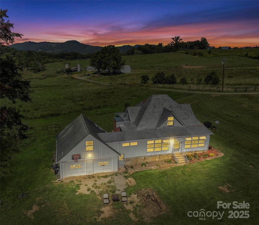 Step back into a simpler time with this enchanting 1890 farmhouse, gracefully nestled beside a gentle stream and overlooking rolling, fenced pastures. Set on a serene slice of Western North Carolina, this property offers the perfect blend of heritage, functionality, and natural beauty.
The pastures are thoughtfully equipped with built-in waters and secure fencing, ready to welcome your livestock. At the lower end, animals can enjoy direct access to the creek—an idyllic touch that speaks to the land’s harmony with nature.
Outbuildings and barns stand ready for your vision, whether you're dreaming of a working farm, a weekend retreat, or a legacy homestead. Each structure holds the promise of purpose, waiting for your personal touch to bring it to life.
2 car garage has attic upstairs for great storage or shop space! 
Whether you're drawn by the whisper of the stream, the view across your own green acres, or the quiet strength of a home that’s stood for generations, this property invites you to write your next chapter in its story.
House has a 4-bedroom septic permit and upstairs could easily be converted into bedrooms.