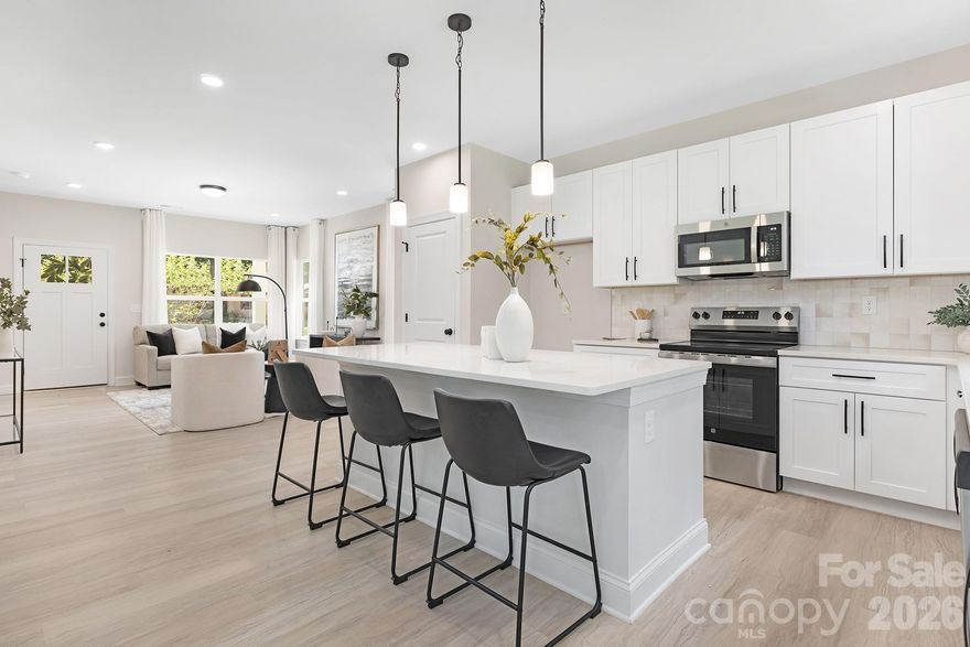 Stunning new construction 5-bedroom single-family home located just 15 minutes from Uptown Charlotte and 15 minutes to the U.S. National Whitewater Center, offering the perfect blend of city convenience and outdoor lifestyle. This move-in ready home sits on nearly half an acre with no HOA and qualifies for 100% financing and up to $20,000 in closing costs. The open floorplan features 9-foot ceilings on both levels, luxury vinyl plank flooring throughout, and a designer kitchen with quartz countertops, white shaker cabinetry with 42” uppers, soft-close doors, dovetail drawers, stainless steel appliances, and black hardware with Moen fixtures. The spacious primary suite includes a dual vanity, and both primary and secondary bathrooms feature designer tile showers extended to the ceiling. Enjoy a dedicated home office on the main level, Pella windows and doors, 2-car garage, rear patio, and expansive backyard perfect for entertaining or relaxing. Ideal for first-time buyers or investors seeking space, upgrades, and location.