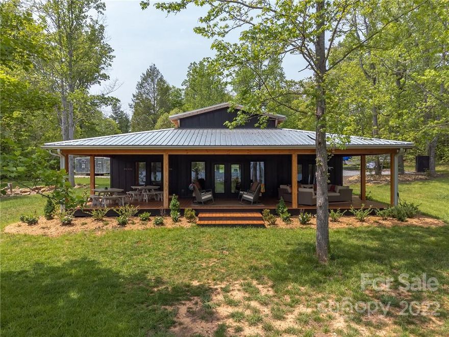 The Lake House on Lake James will make your lake dreams a reality.  The level lot makes access to the water a breeze.The Lake House offers a spacious open floorplan that invites occasions to entertain and gather all while enjoying spectacular views of natural wooded wonders and the sparkling Lake James just outside.   The home comes fully furnished. Everything from the well equipped kitchen featuring a ZLine gas range, to the butternut dining room table, comfortable seating in front of the gas fireplace, memory foam mattresses for the bedrooms, smart TVs, and each bedroom has its own full bath. Of course, you will be spending most of your time outdoors on the massive covered porch and enjoying the outdoor firepit.  Waterfront features a nice beach area, a boat ramp, walkway into the lake (dock permit issued should you like a dock as well). 2 RV parking spaces with hookups.