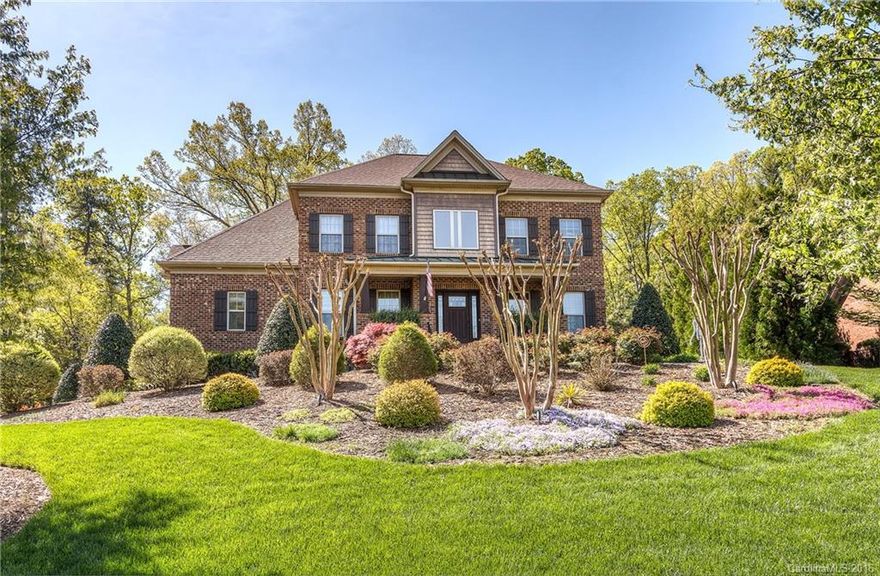 Spectacular custom brick residence has resort feel w saltwater pool, patio, covered porch, outdoor FP, seasonal Lake Wylie view. Inside popular amenity neighborhood next to custom waterfront homes. 2-story greatroom, lg dining room & butler's pantry. Well equipped kitchen, granite & SS, dbl ovens. Main level master to pool, custom closet, luxury bath, office access. Oversized 3-car garage, space for workshop. HUGE bonus w wet bar up 2nd staircase. Concrete slab in tall crawl for garden storage.