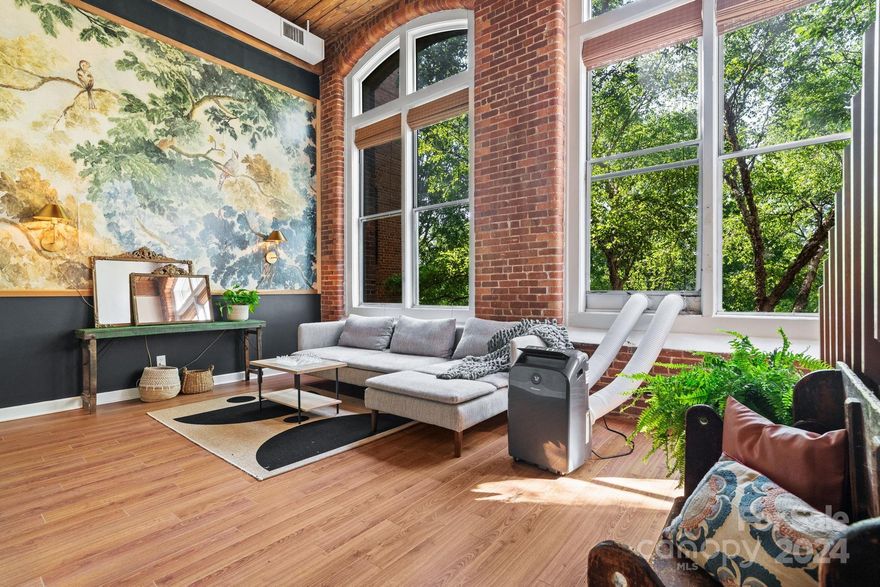 Experience the essence of urban living in this charming two-bedroom condo at 201 Hoskins Road, Unit 225. Nestled in the historic Hoskins Mill Community, this unit offers unique features including in-unit temperature control and the convenience of in-unit laundry. Enjoy the privacy highlighted by two-story brick walls, exposed ductwork, beams, and wood ceilings complemented by large windows. The spacious great-room is ideal for gatherings. The kitchen with island seamlessly connects to the great-room. A full bath with ceramic tile flooring and a walk in shower enhances the appeal. Upstairs, a second bedroom with stunning views of a custom mural completes the living experience. With ample parking in the community, embrace the charm and convenience of this exceptional property.

HOA covers water, sewer, trash as well as partial insurance and maintenance of the building.
Property qualifies for a historic tax credit.