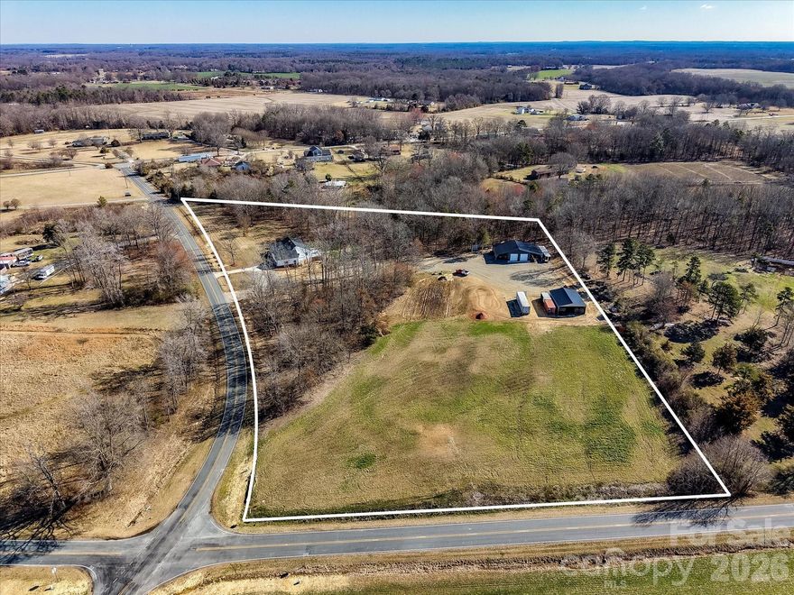 7.18 Gorgeous Acres in highly sought after Union County, NC! Land can be divided. Currently a residential estate with, 30x40 insulated shop with two16-foot sheds on each side, private office and ready to go for your home office! This space could potentially be a barn dominium! Second Barn is 30x40 with 12-foot ceilings plus a ready-to-use chicken coop. Open land for gardening or fencing for horses. Corner acreage with road frontage on two main roads. Home is remodeled to perfection with too many upgrades to list! This family estate is a MUST SEE! UNDER APPRAISED VALUE! Gorgeous, remodeled home with modern finishes throughout.  Pulling up to this lovely estate feels like an escape from the outside world. The detail and warmth are inviting. Cozy front porch spans the majority of the front of the home. Ideal for rocking chairs! Grand entrance with a captivating stone fireplace. The floor plan is open and ideal for entertaining. Spacious kitchen with new appliances! Formal Dining room and sprawling great room. Large primary ensuite with captivating primary bath. New and stylish, featuring all the amenities. Walk in closet. Large mud room with tons of cabinets and counter-top space, ideal for canning. Character throughout! Two car, oversized garage. New roof, gutters, vinyl siding, Renewal Anderson windows (lifetime warranty), garage doors, water heater, and more! This place is a dream! Call today! Will not last! One of a kind.
