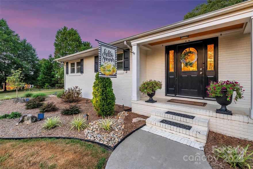 Discover the perfect blend of modern updates & peaceful country living at 820 Green Pond Road in Clover—located in the highly rated Clover School District! Updated all-brick, one-level home on 5+ private acres. Enjoy a serene setting with mature trees, a creek bed water feature, & frequent deer sightings. Inside features a renovated kitchen with granite, stainless appliances, bamboo floors, & gas range. Dining room has fireplace with gas logs; living area offers box trey ceiling, recessed lighting, paddle fans, & pocket doors. Owner’s retreat includes a spa-like bath with double quartz vanity, step-in shower & floor-to-ceiling tile. Beautiful wood floors, plantation shutters, updated baths, whole-house attic fan, & low-voltage outdoor lighting add charm. Relax in the sunroom or on the hardscape patio overlooking professional landscaping. Newer HVAC, storage building, & mini-split system for oversized side-load garage complete the package. Country living with comfort, style & space!