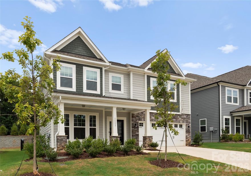 The kind of home buyers wait for in Steel Creek! Located in the sought-after Avienmore community, this beautifully customized five-bedroom, four-bath home stands out with over 3,000 square feet of thoughtfully designed living space and upgrades throughout. From the moment you walk in, the designer finishes, elevated trim work, and warm modern style make an immediate impression. The kitchen was built to be the heart of the home, featuring an oversized quartz island, farmhouse sink, GE stainless steel appliances, custom hood, and a walk-in pantry system designed for everyday function and entertaining. The open-concept layout flows effortlessly into the living area with a statement gas fireplace and abundant natural light. A main-level guest suite with full bath offers flexibility for visitors or multigenerational living, while upstairs you’ll find a spacious loft, three additional bedrooms, and a stunning primary retreat complete with tray ceiling, custom closet system, and spa-inspired shower. Outside, enjoy a fully fenced backyard, expanded paver patio, and covered patio perfect for relaxing evenings or hosting friends. Additional highlights include a finished garage with built-in storage, EV charger outlet, tankless water heater, and WiFi-enabled garage access. Conveniently positioned near shopping, dining, parks, Lake Wylie, Charlotte Douglas International Airport, and everyday essentials, this is one of those homes that truly checks every box.