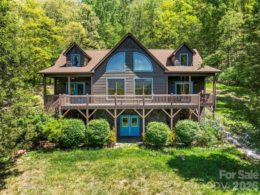 Nestled in the Sandy Mush community of Leicester, this updated 3-bedroom, 2.5-bath cabin/mountain home sits on 15.6 private acres with year-round long-range mountain views—just 30 minutes from Asheville. Recent improvements by current owners include a new roof, interior and exterior paint, deck repairs and staining, septic tank work, water filtration system, kitchen updates, and a newly upgraded primary bath including a new freestanding tub and separate shower area. Warm and inviting interior spaces feature a main-level primary suite, living room, dining area open to the kitchen, and a flex room ideal for an office or additional living space. The upper level offers two bedrooms, a full bath, and a shared living/flex area. A large unfinished walk-out basement provides room to grow and includes a two-car garage area. This property offers peaceful, private mountain living surrounded by nature, with ample space to create your ideal retreat. Book your showing today to see this beautiful property!