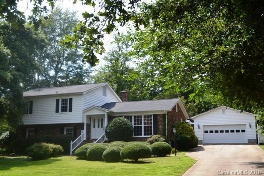 This home will not last long!  Beautiful home with hardwood and ceramic tile flooring throughout!  Large formal living room, dining room, great room with fireplace!  Updated kitchen with granite and tile counter tops, maple cabinets, gas cook top!  Four bedrooms and three full baths.  Huge covered deck is great for entertaining, fenced back yard, and patio.  Detached double garage and workshop!  Great access to I-77, shopping and restaurants.