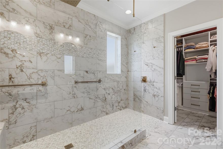 Stunning M/I Home Built in 2020 – A Rare Opportunity! This beautifully designed 1.5-story home offers the perfect blend of luxury, comfort, and thoughtful upgrades—ideal for downsizing, upsizing, or anyone seeking an elevated living experience. From the moment you step inside, light engineered hardwoods set an inviting tone and flow throughout most of the main level. The formal dining room is a true showpiece, featuring custom millwork, crown molding, window trim, and an exquisite ceiling detail that sets this home apart. The craftsmanship and millwork continue throughout the home, adding a refined touch of luxury.  The chef’s kitchen impresses with champagne-gold hardware, a stylish backsplash, under cabinet lighting, upgraded faucet, and a newly finished custom pantry and storage closet. The great room is warm and welcoming, highlighted by a gorgeous stone fireplace. The primary suite takes this home from exceptional to unforgettable. Enjoy custom wall molding, upgraded carpet, and a spa-inspired en-suite bathroom that feels straight out of a magazine. The zero-entry shower (ADA accessible) features champagne-gold fixtures and state-of-the-art shower equipment. Beautiful tilework, recessed storage cabinetry, and a meticulously designed custom closet complete this luxurious retreat. Upstairs, you’ll find a generous bonus room, a full bath, and a spacious additional bedroom—perfect for guests, hobbies, or a private workspace. All this comes with a private wooded backyard and added convenience the blinds in the kitchen, great room, and primary bedroom are app-controlled and can be programmed to raise and lower automatically throughout the day--can we say SHOWSTOPPER! Additional upgrades include enhanced garage storage and a new garage door opener installed in 2025. If you’ve been searching for a ranch or story-and-a-half home with true craftsmanship and standout details, this is the one. Schedule your showing today and experience this spectacular property in person