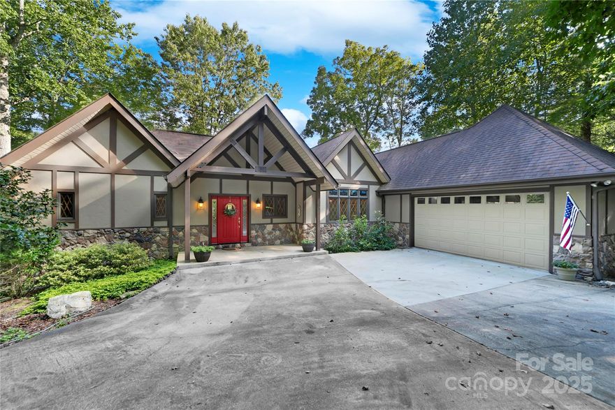 Welcome to lake living at it's finest on highly desirable Lake Ticoa in the beautiful gated community of Connestee Falls.  This custom built elegant home is 4 bedrooms and 2.5 baths with main level living.  Sitting on a deep and wide cove of Lake Ticoa, this is a level walk out lot with extremely easy lake access.  Main level features the primary bedroom suite with double walk in closets and gorgeous lake views from your bedside.  The great room is truly stunning with custom made solid wood beams that show off the vaulted ceilings and floor to ceiling rock fireplace.  The beams continue in to the light and bright kitchen with more lake views and an eat in area perfect for your morning coffee!  Kitchen also features a center island, work desk and ginormous walk in pantry.  Lower Level feels nothing like a basement with 10 foot ceilings and lake views from every room.  Flagstone walk out patio takes you to a level walk right to your dock! New buyer to pay UAF of $13,500 at closing.