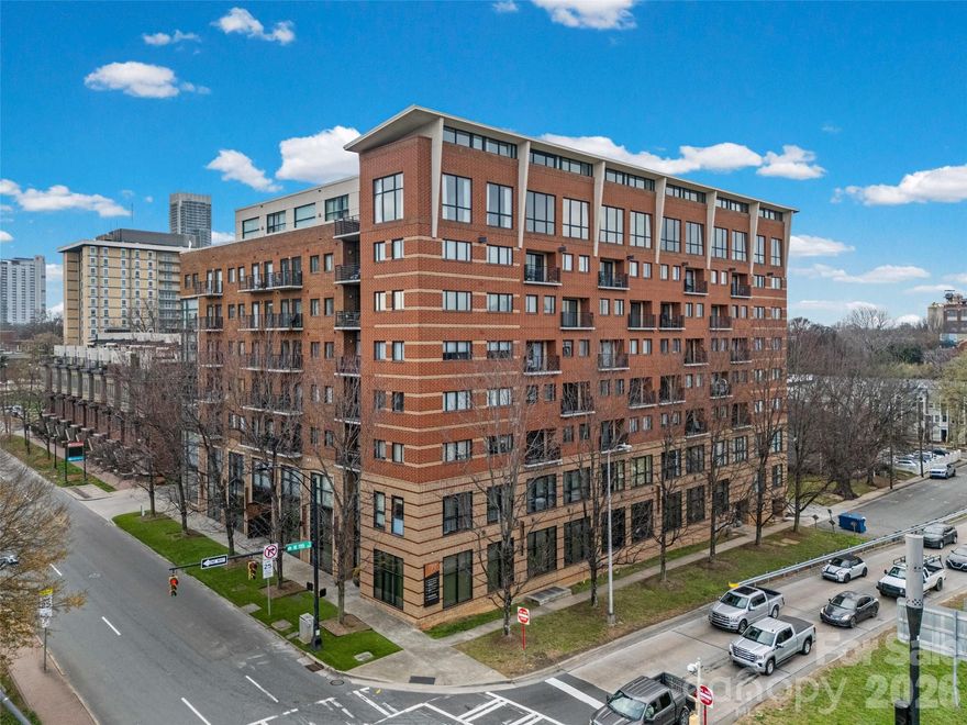 Located on the 7th floor corner of a beautiful Fourth Ward building, this two-bedroom, two-bathroom condo offers stunning year-round views of the Uptown skyline. The home features neutral paint tones, updated flooring, and plenty of natural light throughout.
The living room includes a gas fireplace and direct access to a private balcony overlooking the community pool. The kitchen is equipped with white cabinetry, stainless steel appliances—including a 2021 gas range and a 2024 dishwasher—and the refrigerator will remain. A convenient laundry closet contains a stackable washer and dryer (2022), which will remain.
The primary bedroom sits on the corner of the unit and features windows along two walls, a closet, and an ensuite bathroom with a shower. The secondary bedroom also enjoys Uptown views and is served by a hall bathroom that includes a large vanity and a tub/shower combination.
The secure building offers controlled key-fob access, a welcoming lobby, elevators, an outdoor pool (with new pool furniture arriving soon!), and a parking garage. This condo includes one assigned parking space. The unit is also just one flight of stairs or a quick elevator ride to the rooftop terrace, where residents can enjoy Uptown views or make use of the grilling station. The HOA recently installed a new roof.
Fourth Ward is known for its charming neighborhood parks, delicious restaurants, and lively seasonal festivals. The condo is located less than half a mile from the 9th Street light rail station and offers easy access to everything Uptown has to offer—including sporting events, nightlife, dining, and the arts.