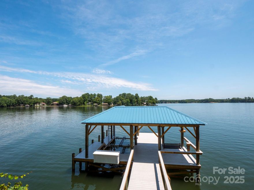 Stunning Open-Channel Lakefront Property with Million-Dollar Views! Located in the heart of Lake Wylie, this exceptional home offers breathtaking, unobstructed lake views and deep-water access with a brand-new dock and pier. Fully renovated, it features 4 bedrooms, 3.5 baths, and spacious walk-in closets. High-end appliances in kitchen with top level granite and flooring. Oversized deck overseeing lake with swing and side area for grilling. The oversized detached garage (31x25 ft) has two bays, a workshop, storage room, and a separate entrance for easy lawn tractor access. Renovated to the studs, it boasts new electrical, plumbing, tankless water heater, water softening system, Ring security, and modern updates—plus extra garage outlets! Relax on the swing at your private boat dock and enjoy stunning sunsets. Don’t miss this rare, fully updated lakefront retreat on over an acre of land for privacy! No HOA!