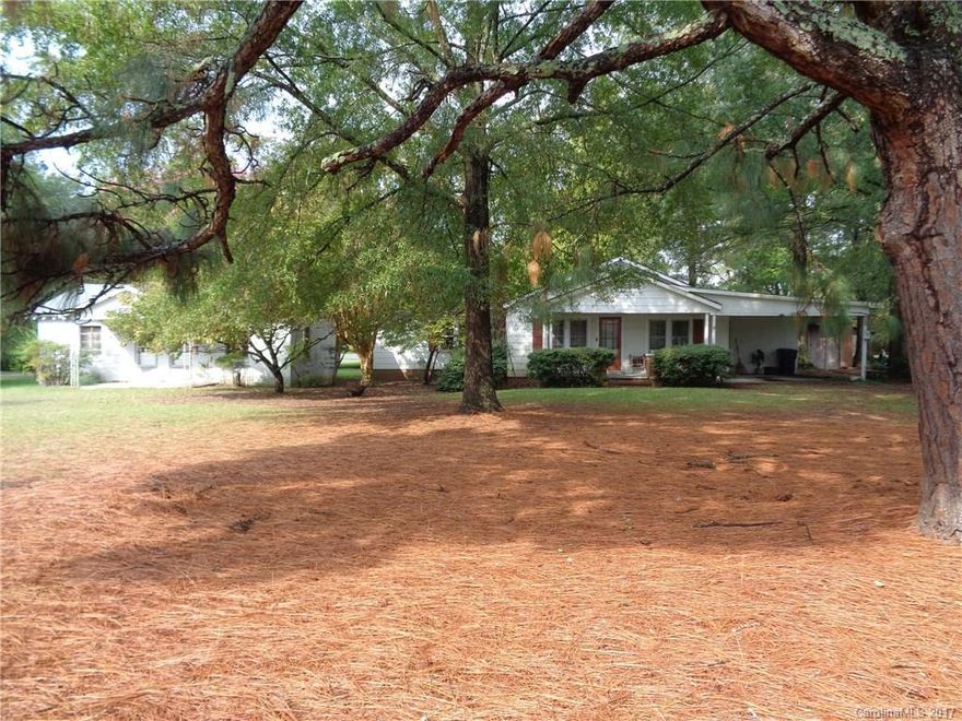 In nice location with front porch and back screen porch .Large master bedroom with extra room.Has a extra building was apartments many years ago now storage building.