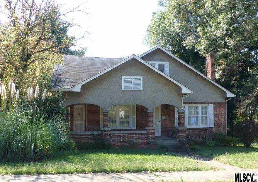 Charming home in great NEWTON location! Beautiful hrdwd floors, lrg rms & lovely details! Spacious formal LR with FP. Adjoining is the formal DR which offers French doors. Somewhat updated kitchen lots of cabinets & a place for a small table (appliances there are fridge, dbl ovens, micro., DW--no repres. of functionality). Enclosed bk porch has lndry hkups. Full bath on main with tile flooring. 1 bedroom with nice closet space. Large den with FP, built-ins & priv. access to front covered porch. The front rm off LR can be used as a study (no closet). Beautiful stairway to 2 addit. "rooms" on the upper lvl-both w/hrdwd flrs, WIC's. Some walk-in attic access. UPPER LEVEL is NOT heated. Unfin. cellar/basement with new vapor barrier. 40' x 24' detached building with a storage room & a single garage door area. Brick and rock facade exterior. 0.40 acre corner lot. Wrap around rocking chair frontporch. Close to Hwy. 321Bus., HWY 10, & Hwy. 16.Walk to dining, theater, & shopping.