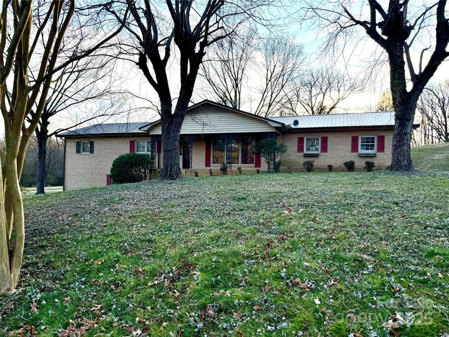 Welcome to this charming brick ranch nestled in a great neighborhood in the Gamewell area of Lenoir. Situated on 2.15 acres, this home offers plenty of space inside and out, making it perfect for multi-generational living or those looking for extra privacy. The main level features 3 bedrooms and 2 full baths, along with a beautifully designed den that’s perfect for relaxing or entertaining. The large back deck provides a great outdoor space to enjoy the peaceful surroundings. Downstairs, the fully equipped in-law suite includes its own kitchen, full bath, private entrance, and driveway, offering endless possibilities for guests, rental income, or extended family. Recent updates include new flooring in the basement, adding a fresh and modern touch. While the pool is not currently in use, the property provides ample outdoor space for recreation, gardening, or simply enjoying the tranquility of this fantastic location.