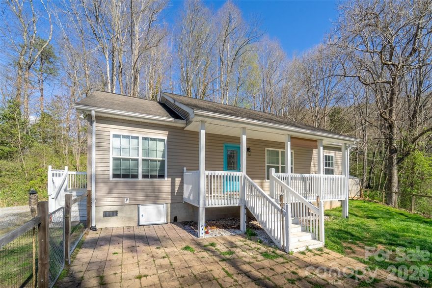 This 3 bedroom, 2 bath home is located within the city limits of Sylva, NC offering the perfect combination of privacy and convenience. Centrally situated with easy access to downtown Sylva, this level home features a spacious eat in kitchen, a primary bedroom with ensuite bath and garden soaking tub, two guest rooms, a mudroom, and a stacked rock gas fireplace. Enjoy outdoor living on the covered front porch and fenced in yard perfect for play and entertaining.
