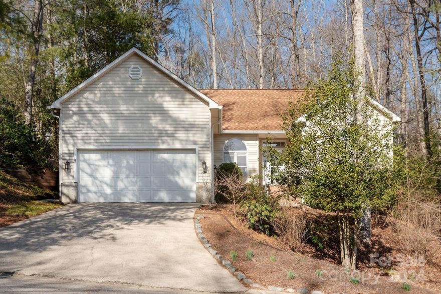 Meditate or entertain to your heart’s content from the stunning, remodeled rear deck and porch overlooking low maintenance backyard of this charming cottage in the woods. Sunlight streams into this home offering 3 BR in a split bedroom plan. Spacious living room has a gas FP, French doors and arched windows. The Kitchen features a Samsung 5 burner gas stove, granite counters and hickory cabinets.  Large, beautifully tiled shower off primary BR. Guest bath has new vanity and newly tiled floor. This house abuts the woodsy perimeter of the association, and has truly one of the nicest rear yards in the community. Easy lifestyle—only 6 houses away are the clubhouse, pool, walking trails and 7 acre lake stocked with trout. Formerly a camp, Deerlake Village is inside the city limits. 5 min drive to artsy foodie Brevard. Hike in nearby National Forest or attend world renowned Brevard Music Ctr concerts. Owner will remove woodworking/sheetrock in garage to restore 2 car capability if desired.