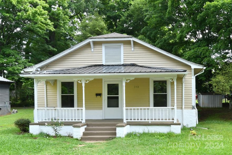 This delightful 3-bedroom, 1-bathroom 1930s bungalow has no HOA fees and features fresh paint both inside and out. The home has been completely renovated, showcasing stunning LVP flooring, granite countertops, a new stove, dishwasher, HVAC system, tankless water heater, cabinets, modern light fixtures, and a refreshed bathroom. Nestled in the lively town of Statesville, which is undergoing a renaissance thanks to residents committed to its enhancement and growth, this property is ideally situated near healthcare facilities, shopping, exceptional local shops and eateries, supermarkets, and entertainment venues, and it is move-in ready. The exterior includes a cozy covered front porch perfect for rocking chairs, a storage shed, and a charming, light-filled sunroom. It's conveniently located with easy access to I-77, I-40, downtown Statesville, and numerous local attractions.