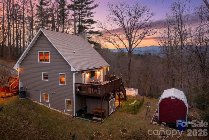 Charming mountain retreat 20 minutes from downtown Asheville, nestled on 4.66 beautiful acres. This adorable 3-bedroom, 2-bath cabin offers the perfect blend of privacy, comfort, and breathtaking mountain views. Enjoy peaceful mornings on the porch overlooking mountain views and evenings surrounded by nature. The spacious acreage provides room to garden, explore, or simply relax and take in the fresh mountain air. Conveniently located just a short drive to local amenities, dining, and shopping, this property offers the best of both worlds—seclusion without sacrificing accessibility. The main level features an open floor plan, a primary bedroom with an ensuite bath, and a vaulted-ceiling living room with a wood-burning stove. Upper-level loft features a large guest bedroom with a tongue-and-groove ceiling. The lower level includes another guest bedroom with an ensuite bathroom, a family room, and a gas fireplace. Exterior garden space and 2 large studio workshops wired with electricity, insulated with a loft for all your hobby needs. Whether you're searching for a cozy vacation getaway, a short-term rental opportunity, or a full-time homestead, this sweet mountain cabin is ready to welcome you home. This property is located in Buncombe County, Marshall. The proposed new Publix in Leicester is just a 10-mile drive. The property would make a great STR with most of the furniture included. Don't miss this rare opportunity to own your own slice of paradise!. Peace, privacy, and panoramic beauty await—all just a scenic drive from quaint Marshall and Asheville.