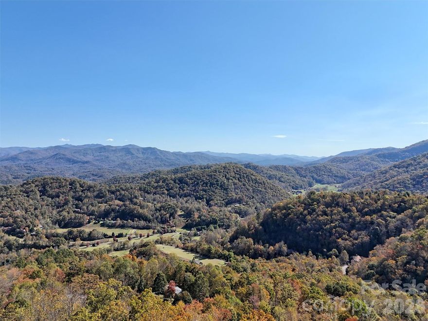 LEVEL AREA WITH STUNNING VIEWS. What an incredible opportunity to build in the UNRESTRICTED community of Indian Trail off of Conley Creek Rd. Primary or second home, great for a vacation rental, or use for off grid living. This lot offers a roughed in driveway, cleared area for building (minus a few trees), magnificent year round views with minimum clearing, and a gravity-fed spring already connected to the lot. There is a 1200 gallon reservoir tank on this lot that is shared with lot 7. Indian Trail has electric throughout, paved roads in most of community, never ending views of the surrounding mountains, and a blend of successful short-term rentals and part-time and full-time residents. 
Come envision your mountain home looking out at the expansive peaks of Soco gap, Richland Balsam, Cherokee, Waterrock Knob, and Cullowhee. Combine this with lot 7 next door for added privacy, Lot 7 even has a negotiable, off-grid structure for temporary shelter while building or vacationing.
***Drone Long range mountain view photos were taken 7 ft above the level area for accurate possible views from a home*** Panoramic video from williamson road (above lots) in links.

Seller is also offering this as a leased lot. Call agent if interested.