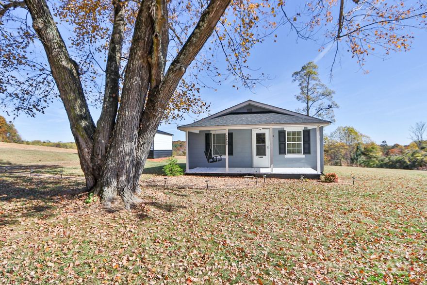 PERFECT LOCATION! Discover peaceful country living just minutes from town! This charming 2-bedroom, 1-bath home sits on a beautiful 1-acre lot surrounded by serene views. Relax on the welcoming covered front porch and take in the peaceful setting. Inside, you’ll find a cozy layout featuring neutral colors throughout, a bright kitchen with a wood top island, comfortable living spaces and an inside laundry area. The spacious yard provides plenty of room for gardening, play, or outdoor gatherings and the detached garage adds great convenience. Conveniently located just 10 minutes from downtown Elkin and 30 minutes from Wilkes County, this home offers the perfect blend of quiet country living and easy access to shopping, dining, and recreation. Schedule a tour today!