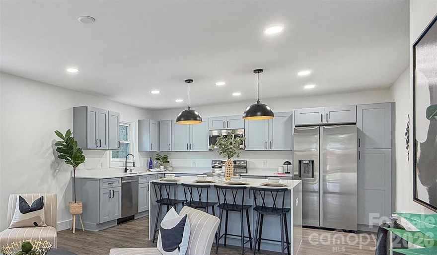 Beautifully renovated home showcasing exceptional workmanship and thoughtful design throughout. This move-in-ready property features a brand-new HVAC system, stylish LVP flooring, and a completely updated kitchen with new cabinetry, quartz countertops, and a stunning waterfall-edge island—perfect for both everyday living and entertaining.

Every detail has been carefully considered, including all new light fixtures and plumbing fixtures, creating a fresh, modern feel from top to bottom. The spacious layout includes a large laundry/mud room, offering both functionality and convenience.
Step outside to enjoy a flat, fully fenced backyard—ideal for gatherings, pets, or simply relaxing in your own private outdoor space.
Conveniently located, this home offers easy access to NoDa, Uptown, and Plaza Midwood, putting dining, entertainment, and major highways just minutes away. 
Enjoy the perfect balance of a quiet residential setting with close proximity to vibrant city living. This is a must-see opportunity you don’t want to miss.