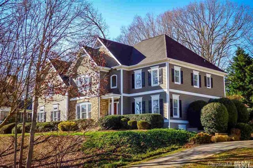 Artful executive home in Moore's Ferry boasts top-quality finishes inside & out! Situated on one of the only wooded lots in the neighborhood, spacious 5BR home offers terraced, tree-lined backyard w/lush lawn & concrete patio. Main lvl features 2-story foyer opening onto lrg formal DR & columned entry to formal LR. Back of house offers open-concept great room w/adjoining kit/breakfast area. 2015, kitchen updated w/flame-finished granite, mosaic tile backsplash, & professional grade appli,...