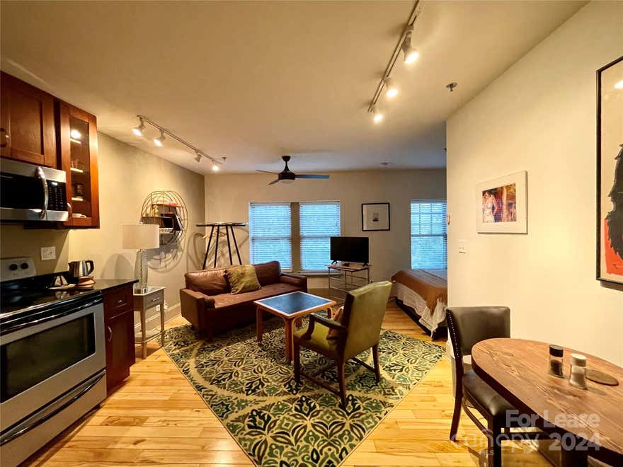 Chic urban loft in Downtown Asheville above 5 Walnut Wine Bar. Absolute central location - walk to most anything.  Month to month full service lease - rent covers all utilities, wifi, surface parking space in gated lot one block away This fully furnished unit includes everything you need: bed linens, towels, cookware, dishes, flatware, cleaning supplies, etc. Perfect for executive rental, relocation stay, or a long vacation in the Blue Ridge Mountains with all the excitement of eclectic Asheville just outside your front door! Pets allowed upon Landlord approval with deposit. Currently in service as short term rental with intermittent occupancy - showings by appointment with listing agent only.