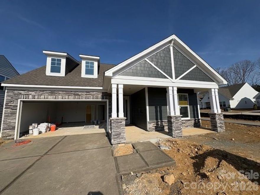 Heritage is a 55+ community close to shopping, dining and other conveniences. This 1.5-story Mayfair plan offers 3 bedrooms, 3 full baths, a screened porch, and more than 2,500 of living area! This plan features an open kitchen with breakfast area that leads into the family room with a gas fireplace with stone surround. The kitchen has white cabinets with a contrasting grey island. The kitchen lower cabinets have been extended to give you extra storage. The kitchen also features quartz counters and stainless appliances, including a gas cooktop, designer range hood and wall oven. The main floor also includes the primary suite with a luxury shower, an office with French doors and faux coffered ceiling, mud room with a beadboard drop zone, a secondary bedroom next to a full bath, and laundry room. The upper floor has a bedroom, full bath, loft and a large unfinished storage area. Enjoy the outdoors on the rear screened porch or paver patio with firepit and seating wall. Community amenities include outdoor pool, clubhouse and cabana, nature trails, and game courts. Year-round lawn maintenance included!