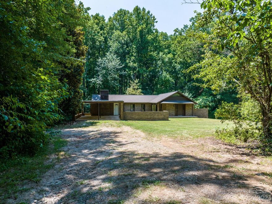 One of a kind--Great investment or private estate opportunity in the bustling town of Newton! New A/C Unit just installed! Nearly 3 acres of land with a beautiful brick ranch w/ full basement tucked away in the woods. Main floor layout has a separate primary bedroom wing w/ ensuite bath, cozy sitting area w/ FP, double closets, & access to the large back deck. A hallway w/ another full bath and basement access separates from kitchen area & large living area open to dining with cathedral ceilings & wood beams. Beautiful details in the architecture of this home. The full basement offers so much potential w/ a full bath, & a separate kitchen area--just needs appliances. Two large separated spaces could be finished to offer extra living space, or can be used as-is for storage. Separate earth drive leads down to the basement. The property also has 3 singlewides currently renting lot space w/ leases in place. Come check out all of the opportunity this property has to offer!