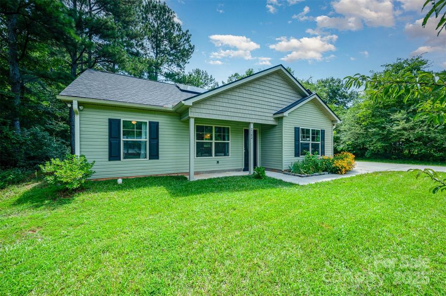 entertain on the extended back patio with a spacious backyard. Inside, the vaulted great room features 5" laminate wood floors and flows into a kitchen with granite countertops and all appliances included. The large primary suite includes a private bath with granite vanity and a walk-in closet. Home includes fully owned solar panels installed in 2023 with additional panels added in 2024—for improved energy efficiency. An 8'x10' storage shed provides extra space. Side-entry laundry room, peach and pear trees, blueberry bush, and flowers complete the outdoor charm. Move-in ready with peaceful surroundings! One-year home warranty offered!