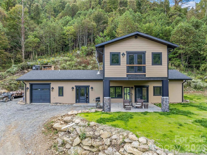 Discover 100+ acres of privacy, freedom, and opportunity at 945 Roaring Fork Road in Hot Springs, NC. Perfect for those seeking off-grid living, sustainable farming, or a private mountain retreat, this unique property sits on part of the Pisgah National Forest and includes part of Cud Gap. With abundant wildlife, natural springs, blackberries, and miles of trails, it’s ideal for hiking, mountain biking, 4-wheeling, hunting, foraging, or simply enjoying the beauty of nature. At the heart of the property is a custom-built home with a jacuzzi and superior foundation walls, heated floors, tiled showers, deep soaking tub, granite countertops, stainless steel appliances, a 100-gallon water heater with boiler hookup, and spray foam insulation. Mountain views enhance the comfort and design, while a garage adds convenience. 

Multiple additional dwellings and structures expand the possibilities: A tiny container home with deck, granite countertops, and mini split. Mobile home with outdoor fireplace (personal property). Climate-controlled greenhouse with radiant heat, hot water heater, and fan. Root cellar, garden area, two chicken coops, goat barns,  plus a pond and creek with beach area. 

For work, storage, or creative projects, the property offers: Shop/Garage #1 with 200-amp electric panel. Shop/Storage #2 with a wood stove, two storage containers, and a hydroelectric system. Infrastructure supports expansion, including a future build site with slab, roughed-in plumbing, and additional septic, plus other potential build areas. This property is perfectly suited for a family compound, homestead, farm, or nature lover’s escape. 100 acres ensure lasting privacy to live sustainably, play freely, and create your legacy on this one-of-a-kind mountain property.