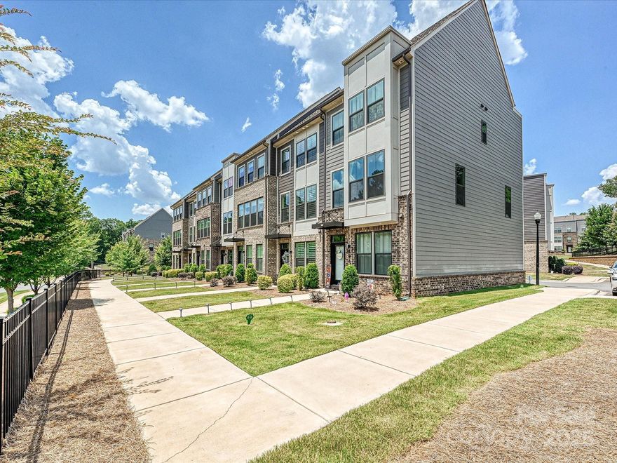 Modern 4-story townhouse offering space, style, and flexibility. The entry level features a 1-car garage, half bath, and a bonus room—ideal for an office, gym, or guest space. The main level boasts an open layout with a spacious living room, dining area, and a large kitchen with center island, plus access to a private balcony. Upstairs, the primary suite includes a full bath, while the second bedroom has its own ensuite and is conveniently located near the laundry closet. The top floor offers a bright open bedroom with a full bath and access to a private terrace—perfect for an independent teen, young adult, or long-term guest. With multiple en-suite bedrooms, two outdoor spaces, and a layout made for modern living, this home checks all the boxes.