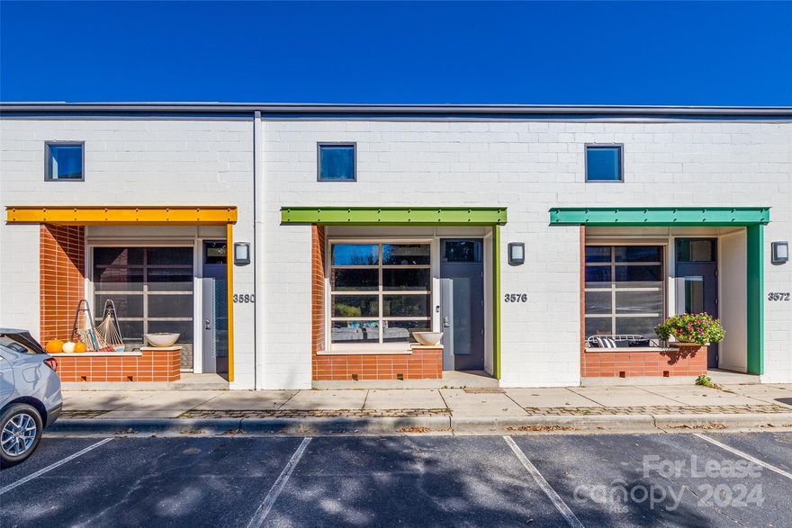 This condo features spectacular 20ft ceilings, entry level concrete floors, and a functional garage door / glass wall that serves as the living room wall opening up to the front patio. Downstairs bedroom is ideal for a home office or guest room, and the owner bedroom is upstairs connected to a spacious loft that can serve as a second living room, home office, den, or study / crafts area. Located only a short walk to the main intersection of the NoDa Arts District at 36th and N. Davidson. An abundance of dinning and entertainment options are at your fingertips with the LYNX Blue Line Light Rail stop in close proximity (~7-10min walk). Included in rent: Spectrum high-speed Cable and internet, water, trash, HVAC quarterly maintenance, landscaping and shared gas grill & fire pit area. Property is fully furnished minus the downstairs office/bedroom.