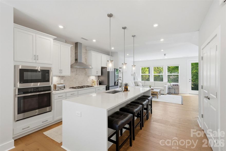 Welcome to Six Twenty—a rare opportunity to own a nearly new, 2022-built luxury 3 bedroom, 3.5 bath END-UNIT townhome in one of Charlotte’s most connected locations.
This home delivers a clean, modern aesthetic with bright natural light throughout. The open-concept upper level has large living room with electric fireplace and is anchored by a chef’s kitchen featuring white cabinetry, a gas cooktop, wall oven, quartz countertops, and a striking waterfall-edge island, all seamlessly connected to the dining area and flexible workspace. This level features a cozy balcony convenient for grilling or entertaining. 
The third level is designed for comfort and privacy, highlighted by a spacious primary suite with tray ceiling, dual closets, and a refined ensuite bath with walk-in shower and double quartz vanity. A secondary bedroom with its own en-suite tub/shower combo and quartz countertop vanity. A well-appointed laundry room with additional storage and decorative tile flooring complete this level.
The main/entry level of the home offers a private guest suite with full bath, ideal for a home gym or office, visitors or multi-generational living, along with a functional drop zone and direct access to the two-car garage. An EV charger is already installed, adding convenience and value.
As an end unit, the home benefits from enhanced natural light and added privacy, elevating the overall living experience. Built in 2022, it offers the advantage of newer construction without the wait, with modern systems, finishes, and efficiency already in place.
Positioned just minutes from Park Road Shopping Center, the dining and entertainment of South End, close to center city Charlotte, and quick access to Interstate 77, this location balances lifestyle and convenience effortlessly.
Homes in this neighborhood are rarely available, and this one combines location, condition, and elevated finishes in a way that stands out immediately. Come tour today!