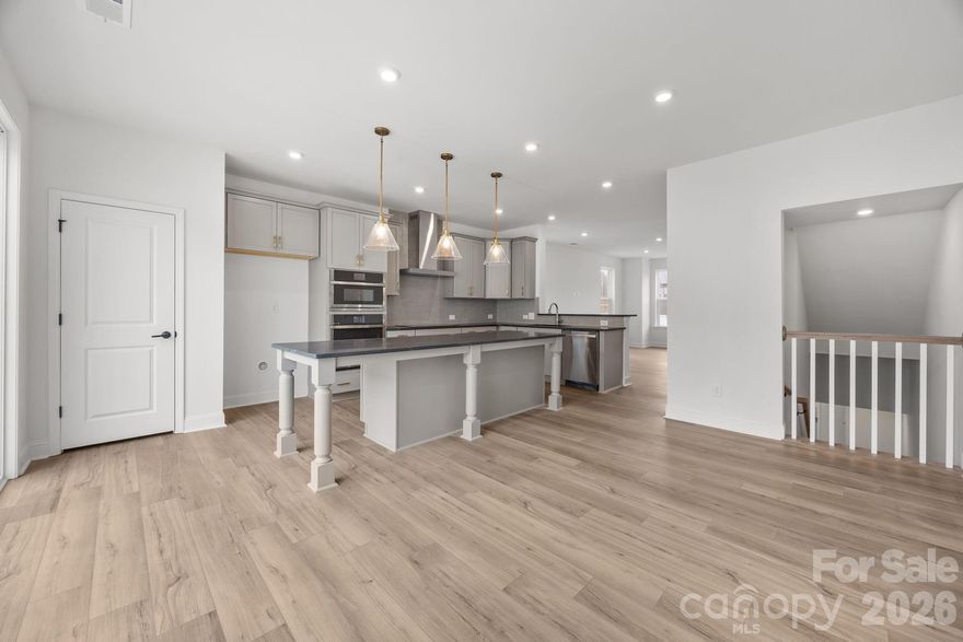 Welcome to The River District—a true master-planned community where lifestyle and location come together beautifully.

This beautifully appointed Landon three-story townhome offers a thoughtfully designed layout with a first-floor guest bedroom and full bath—perfect for visitors, multigenerational living, or a private home office.

The second level showcases a gourmet kitchen featuring quartz countertops, a built-in oven and microwave, electric cooktop, and soft-close cabinetry. The open-concept dining and living areas create an inviting space ideal for entertaining, while sliding glass doors lead to your private balcony—perfect for relaxing or enjoying your morning coffee.

Upstairs, you’ll find two beautiful owner’s retreats, each offering a bright, airy bedroom and a spa-inspired bath for ultimate comfort and privacy. A conveniently located laundry area completes the upper level.

This home is filled with beautifully curated interior finishes, individually hand-selected by our professional design team, creating a cohesive and elevated aesthetic throughout.

Location is everything—and at The River District, you’re truly minutes from it all. Planned community amenities include a resort-style pool, clubhouse with fitness center, tennis and pickleball courts, parks, scenic trails, a working two-acre farm with an on-site farmer, and a riverfront amphitheater.

Experience vibrant, connected living in one of the area’s most exciting communities.